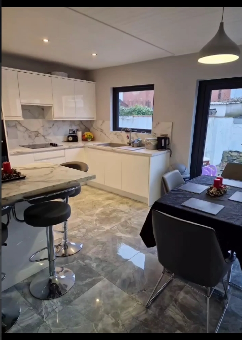 White marble open-plan kitchen with island, Dublin renovation