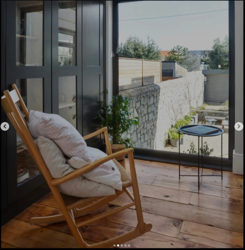 Sunroom with rocking chair and garden view